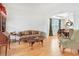 Cozy living room showcasing hardwood floors, traditional furniture, and a view to the dining area at 3060 Elmwood Ct, College Park, GA 30349