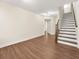 Basement with wood flooring, staircase, and neutral paint; a versatile space at 4343 Ainsley Mill Ln, Duluth, GA 30097