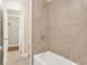 Bathroom featuring a tiled shower/tub combo, with a toilet and linen closet visible in the background at 4343 Ainsley Mill Ln, Duluth, GA 30097