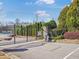 Community entrance with wrought iron gates, lush landscaping, and clear signage at 4343 Ainsley Mill Ln, Duluth, GA 30097