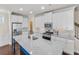 Modern kitchen with white cabinets, granite countertops, stainless steel appliances, and an island at 4343 Ainsley Mill Ln, Duluth, GA 30097