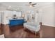 Spacious living room with hardwood floors, modern furniture, and a view into the kitchen at 4343 Ainsley Mill Ln, Duluth, GA 30097