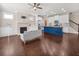 Open-concept living room with hardwood floors, fireplace, and a kitchen island at 4343 Ainsley Mill Ln, Duluth, GA 30097