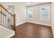 Living Room with wooden staircase, hardwood floors, and natural lighting at 4343 Ainsley Mill Ln, Duluth, GA 30097