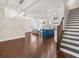 Open-concept living area with hardwood floors, kitchen island, and staircase at 4343 Ainsley Mill Ln, Duluth, GA 30097