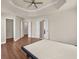 Spacious main bedroom with a tray ceiling, wood floors and multiple closets at 4343 Ainsley Mill Ln, Duluth, GA 30097