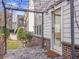 Cozy outdoor patio with string lights, brick accents, and lush greenery at 4343 Ainsley Mill Ln, Duluth, GA 30097