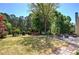 Backyard features a patio, outdoor seating, mature landscaping, and trees at 5221 Huntcrest Sw Pl, Mableton, GA 30126