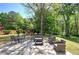 Backyard features a patio, outdoor seating, mature landscaping, and trees at 5221 Huntcrest Sw Pl, Mableton, GA 30126