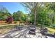 Spacious backyard with patio, outdoor furniture, and mature trees, perfect for relaxing at 5221 Huntcrest Sw Pl, Mableton, GA 30126