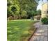 Serene backyard with well-manicured lawn, patio with seating, and a charming swing, perfect for outdoor relaxation at 5221 Huntcrest Sw Pl, Mableton, GA 30126