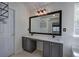Bright bathroom with dual sinks, framed mirror, neutral walls and vanity with storage at 5221 Huntcrest Sw Pl, Mableton, GA 30126