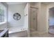 Bright bathroom featuring a soaking tub, separate shower, and elegant fixtures at 5221 Huntcrest Sw Pl, Mableton, GA 30126