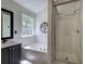 Bright bathroom featuring a large soaking tub, vanity with sink, and stand-up shower at 5221 Huntcrest Sw Pl, Mableton, GA 30126