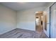 View of a carpeted bedroom with an open door leading to an en-suite bathroom at 5221 Huntcrest Sw Pl, Mableton, GA 30126