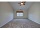 Large carpeted bedroom featuring a vaulted ceiling, ceiling fan, and natural light at 5221 Huntcrest Sw Pl, Mableton, GA 30126