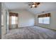 Spacious carpeted bedroom with a vaulted ceiling, ceiling fan, and bright, natural light at 5221 Huntcrest Sw Pl, Mableton, GA 30126