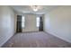 Spacious carpeted bedroom with dual windows and neutral paint, with an overhead fan at 5221 Huntcrest Sw Pl, Mableton, GA 30126