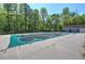 Community pool covered for the off season, surrounded by lush trees, offering a serene recreational space at 5221 Huntcrest Sw Pl, Mableton, GA 30126