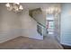 Dining area with decorative chandelier, wainscoting, and view of the staircase leading to the upper level at 5221 Huntcrest Sw Pl, Mableton, GA 30126