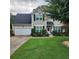 Charming two-story home with a well-manicured lawn and neat landscaping creating a welcoming curb appeal at 5221 Huntcrest Sw Pl, Mableton, GA 30126