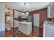 Well-lit kitchen features stainless steel appliances, a center island, and lovely hardwood floors at 5221 Huntcrest Sw Pl, Mableton, GA 30126