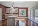 Modern kitchen with a large island, stainless steel appliances, and a view of the backyard through sliding doors at 5221 Huntcrest Sw Pl, Mableton, GA 30126