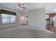 Bright living room features hardwood floors, neutral walls, and a view of the foyer and modern kitchen at 5221 Huntcrest Sw Pl, Mableton, GA 30126