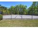 Community tennis court enclosed by a chain-link fence and surrounded by trees, offering a recreational space at 5221 Huntcrest Sw Pl, Mableton, GA 30126