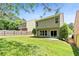 Green backyard featuring well-maintained grass, trees, and a wooden fence at 7705 Bellmist Dr, Fairburn, GA 30213
