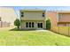 Well-maintained backyard features green grass and a sliding glass door leading to the home's interior at 7705 Bellmist Dr, Fairburn, GA 30213