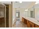 Bright bathroom featuring double sinks, granite counters, and a glass shower with tile surround at 7705 Bellmist Dr, Fairburn, GA 30213