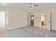Spacious carpeted bedroom with multiple closets and doors, offering ample space and storage at 7705 Bellmist Dr, Fairburn, GA 30213