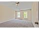 Carpeted bedroom with ceiling fan and two windows allowing natural light at 7705 Bellmist Dr, Fairburn, GA 30213