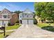 Charming two-story home features a two-car garage and manicured front lawn, perfect for suburban living at 7705 Bellmist Dr, Fairburn, GA 30213