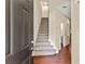 Bright foyer featuring hardwood floors and staircase with contemporary design, leading to upstairs at 7705 Bellmist Dr, Fairburn, GA 30213