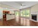 Open living space with hardwood floors, modern fireplace, and natural light from sliding glass doors at 7705 Bellmist Dr, Fairburn, GA 30213