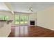 Bright living room boasts a fireplace and large windows overlooking the backyard at 7705 Bellmist Dr, Fairburn, GA 30213
