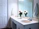 Bright bathroom with a double vanity, a large mirror, and clean, white decor at 821 Tramore Ct, Powder Springs, GA 30127