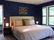 Cozy bedroom with dark blue walls, a plush bed, and natural light from the windows at 821 Tramore Ct, Powder Springs, GA 30127