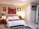 A cozy bedroom with a bed, side table, and sports memorabilia on the walls at 821 Tramore Ct, Powder Springs, GA 30127