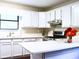 Bright kitchen with white cabinets, stainless steel appliances, and a functional island at 821 Tramore Ct, Powder Springs, GA 30127
