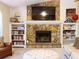 Inviting living room with a stone fireplace, built-in shelves, and comfortable seating for relaxing and entertaining at 821 Tramore Ct, Powder Springs, GA 30127