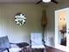 Cozy outdoor patio with seating, a 'Welcome' sign, and an umbrella for shade at 821 Tramore Ct, Powder Springs, GA 30127