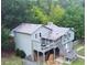 View of rear of home with multiple decks, stairs, and woodpile at 821 Tramore Ct, Powder Springs, GA 30127