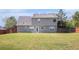 View of the backyard, showcasing a large lawn and fenced perimeter at 1000 Brushystone Dr, Loganville, GA 30052