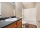 Bathroom featuring a vanity with dark countertop and a shower-tub combo at 1000 Brushystone Dr, Loganville, GA 30052
