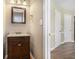 Half bath with vanity and dark wood cabinet at 1000 Brushystone Dr, Loganville, GA 30052