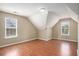 Attic bedroom with wood floors, neutral paint, dormer windows and unique ceiling lines at 1000 Brushystone Dr, Loganville, GA 30052