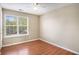 Bright bedroom with wood floors, neutral walls, ceiling fan, and window with blinds at 1000 Brushystone Dr, Loganville, GA 30052